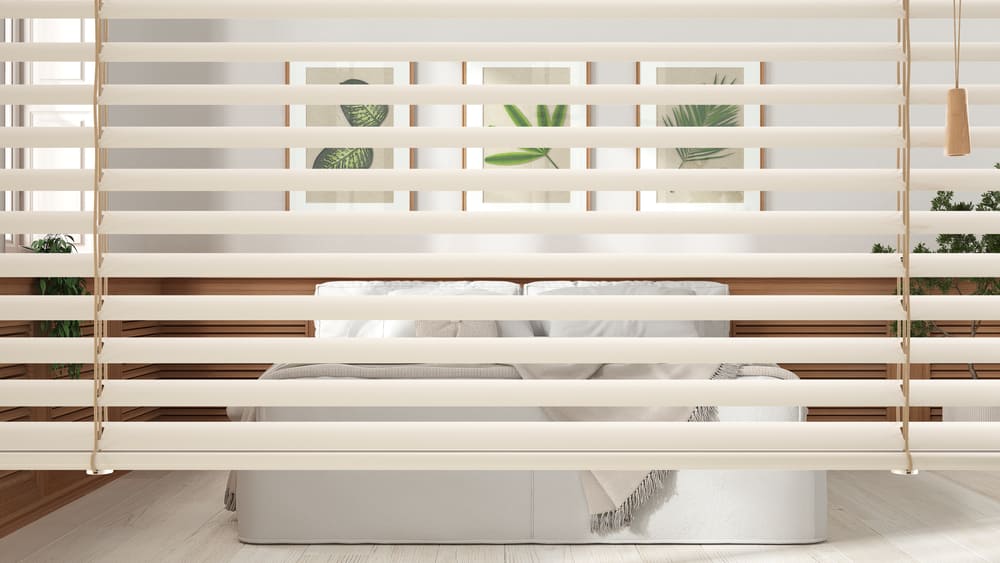 White venetian blinds close up view, over scandinavian bedroom with double bed and wooden wall panel, interior design, privacy concept